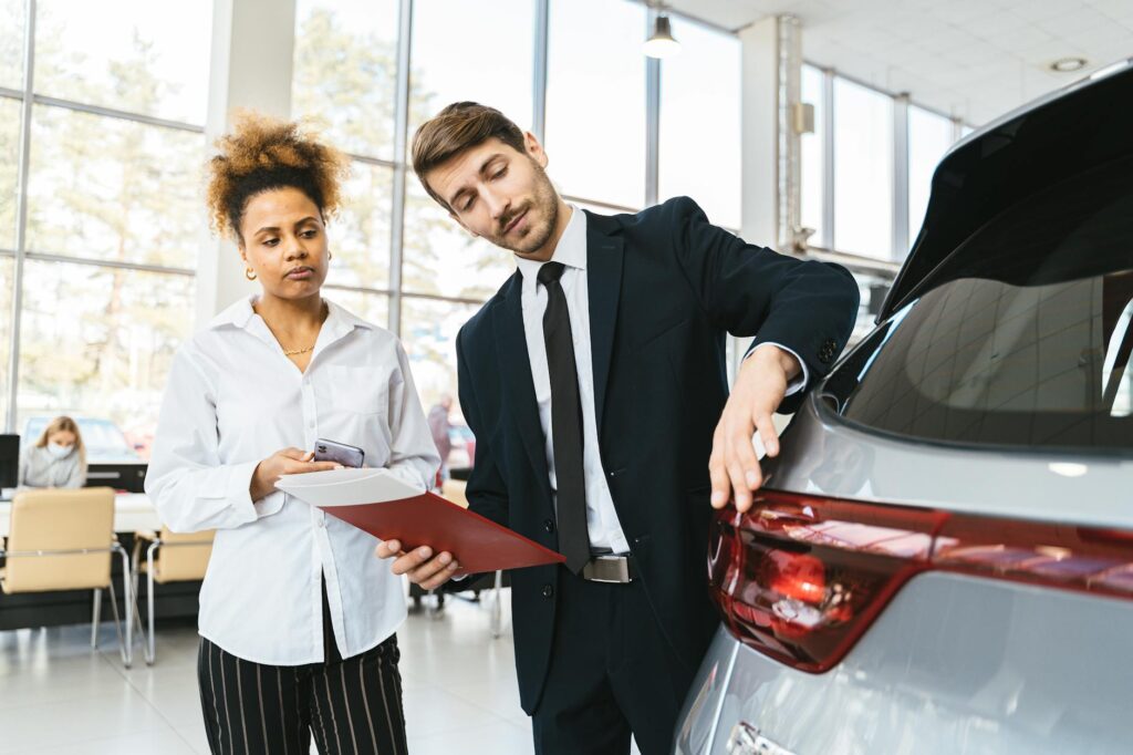 A foreign driver discussing options with a rental agent at a Nevada rental car office. — rental car insurance internatio…