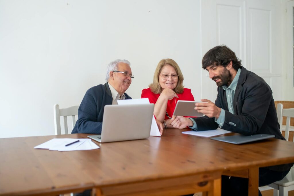 A photo of a family discussing car insurance options around a table, illustrating how to compare car insurance rates Nevada