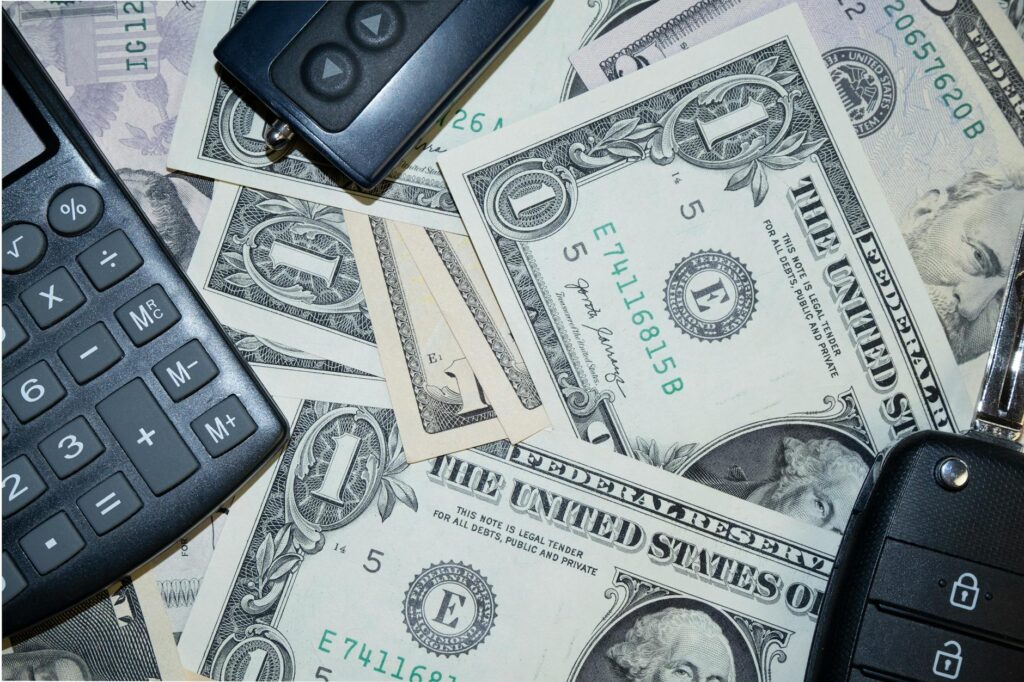 An image of a car with a dollar sign to represent insurance costs. — credit score car insurance Nevada