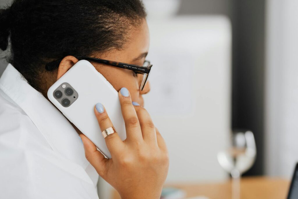 An image of a person on the phone with their insurance provider after an accident. — file car insurance claim Nevada