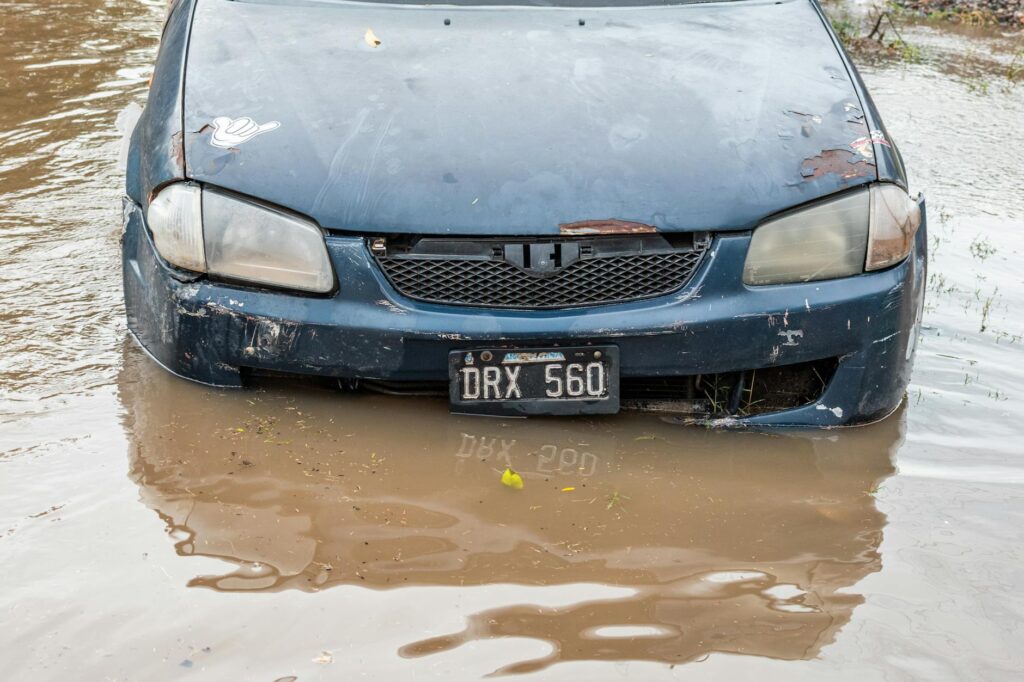 An image of a vehicle being affected by extreme weather, such as a dust storm or heavy rainfall, illustrating the impact o…