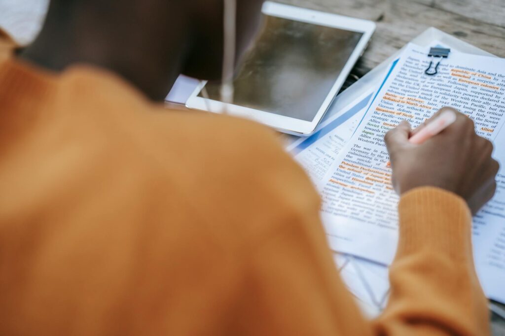 Image of a student studying with a car nearby, highlighting good student discounts. — car insurance discounts Nevada