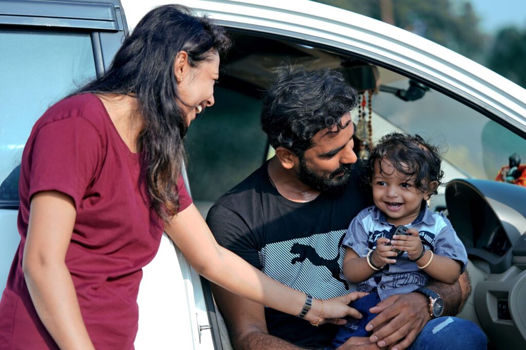 A photo of a happy family with their car, symbolizing peace of mind with their insurance. — top car insurance providers …