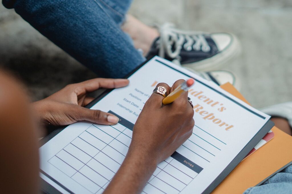 Image of a student with a report card for good student discounts — Nevada car insurance discounts