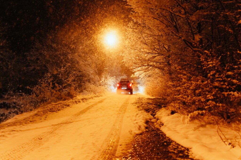 A photo of a car in snowy conditions to illustrate winter driving risks. — Nevada car insurance weather impact