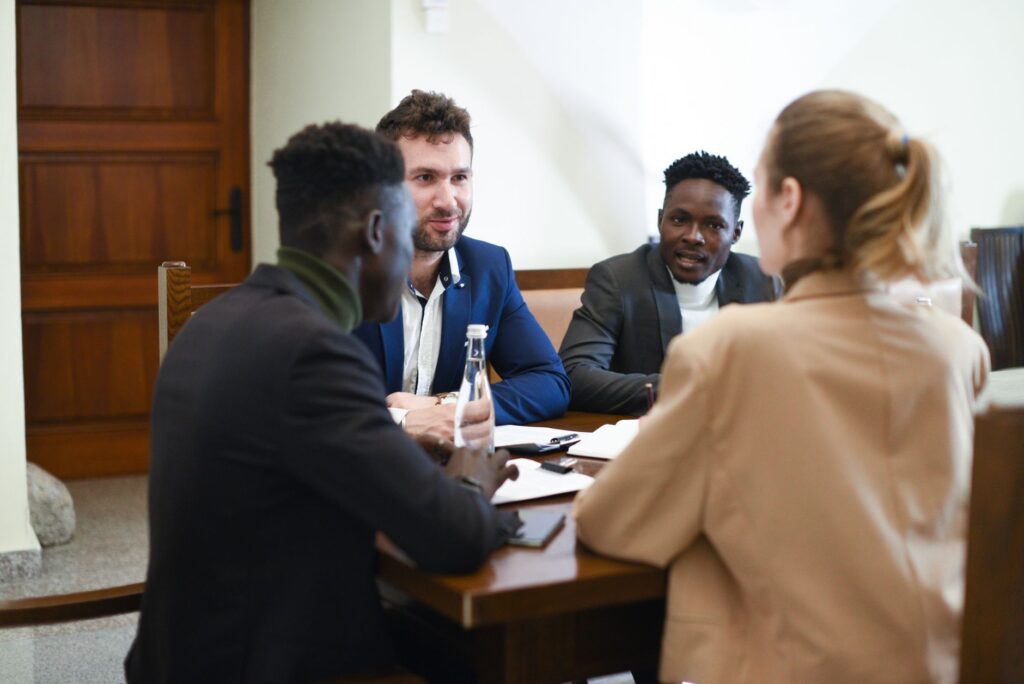 A photo of a diverse group of drivers discussing insurance options, reflecting the diversity of Nevada car insurance rates.