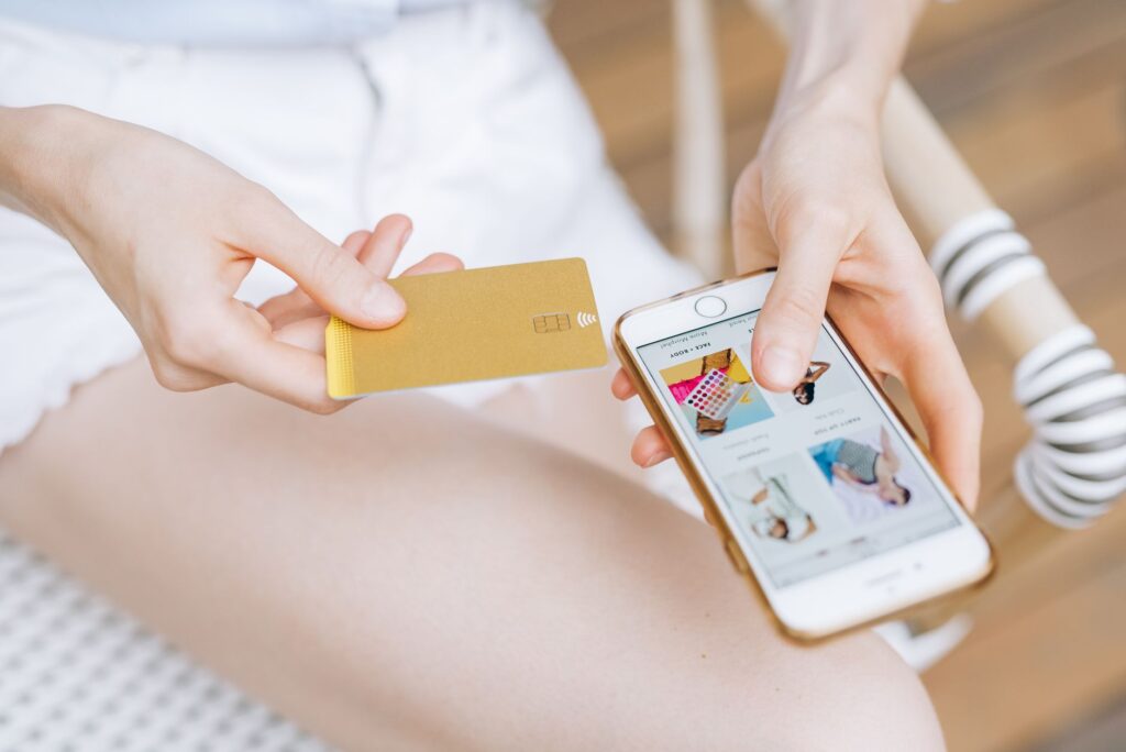 Image of a person comparing car insurance quotes online to illustrate the importance of shopping around. — lower car ins…