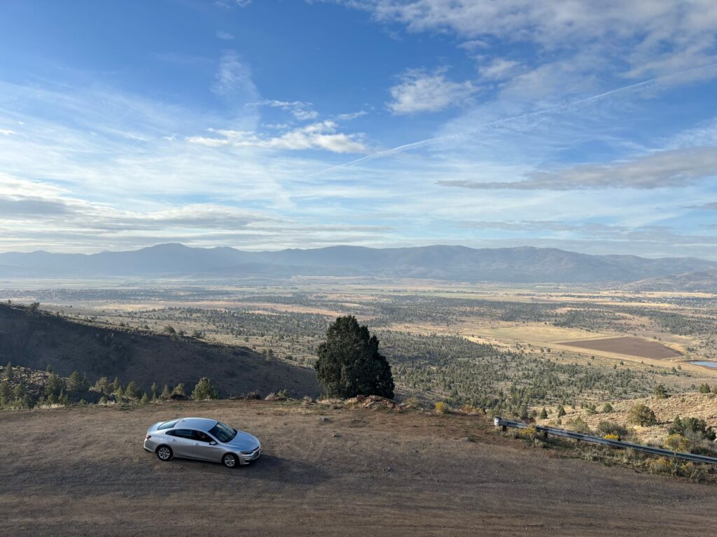 Photograph of a typical desert landscape in Nevada with a car on the road — Nevada geography car insurance