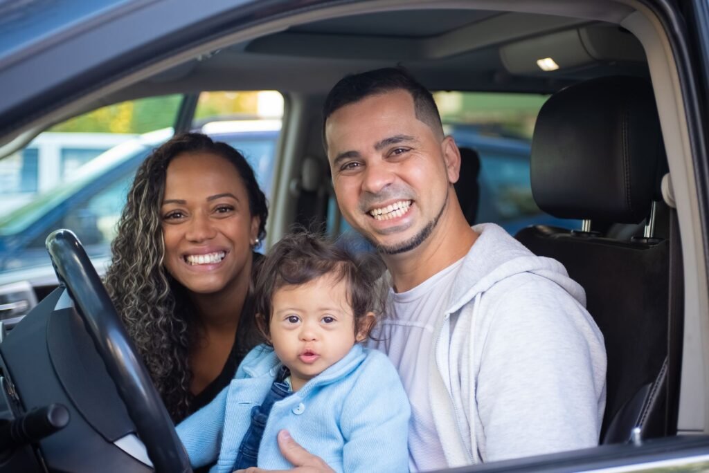 A happy family with a car, representing safe driving and low insurance costs — affordable car insurance Nevada