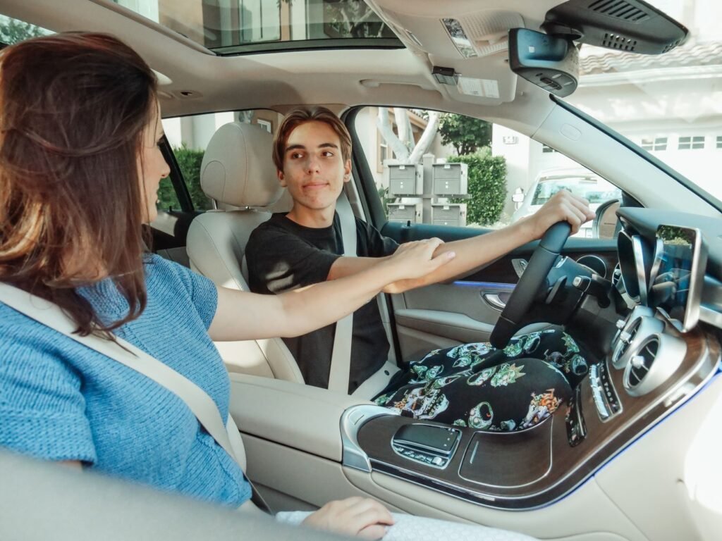 A photo of a parent teaching their teen to drive safely. — Nevada car insurance teen drivers