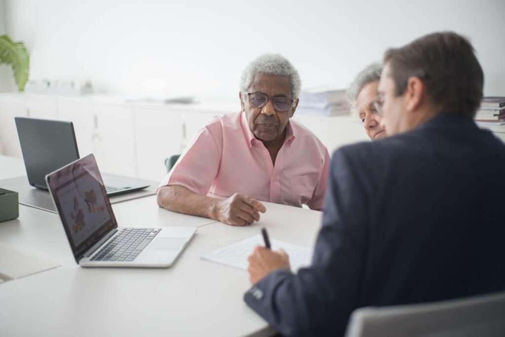 A picture of a family discussing insurance options with a broker. — car insurance young drivers Nevada