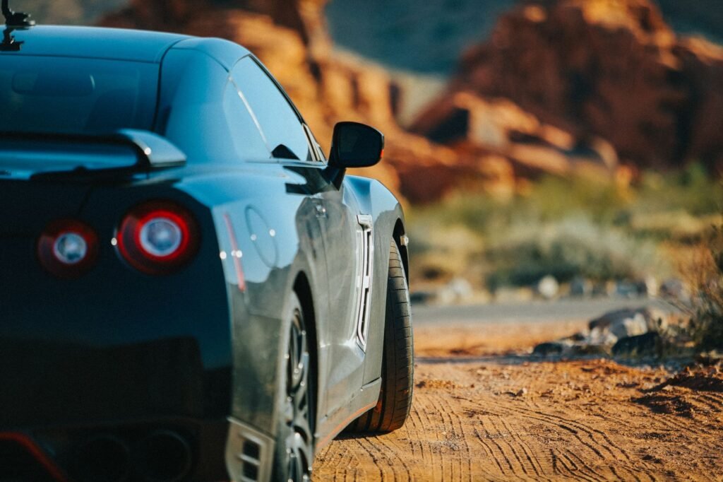 A scenic view of Nevada's landscape with a car on the road — car insurance new residents Nevada