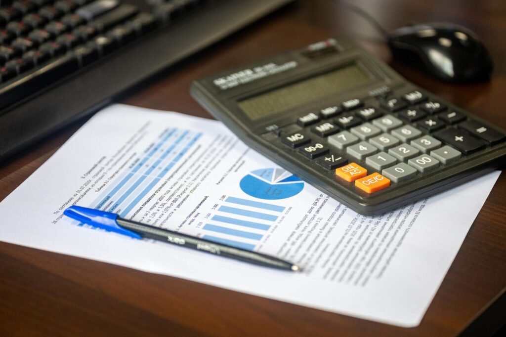 An image of a calculator and financial documents to symbolize budgeting for car insurance. — save on car insurance Nevada