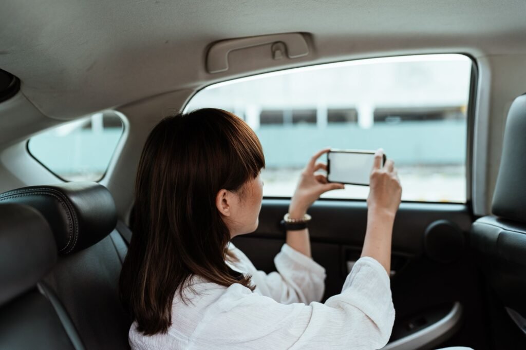 Photo of a person documenting a car accident with a smartphone. — after car accident Nevada insurance