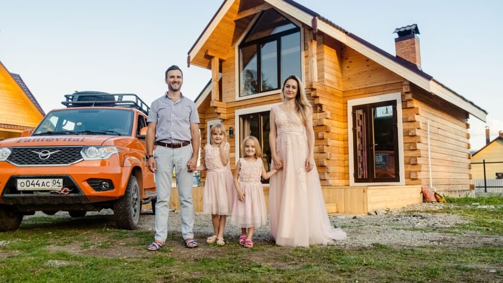 A happy family standing in front of their home and car, symbolizing the peace of mind from bundled insurance. — bundling…