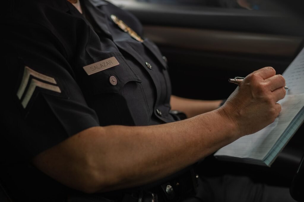 A photo of a police officer taking notes at an accident scene, highlighting the importance of proper documentation for car accident insurance Nevada claims.
