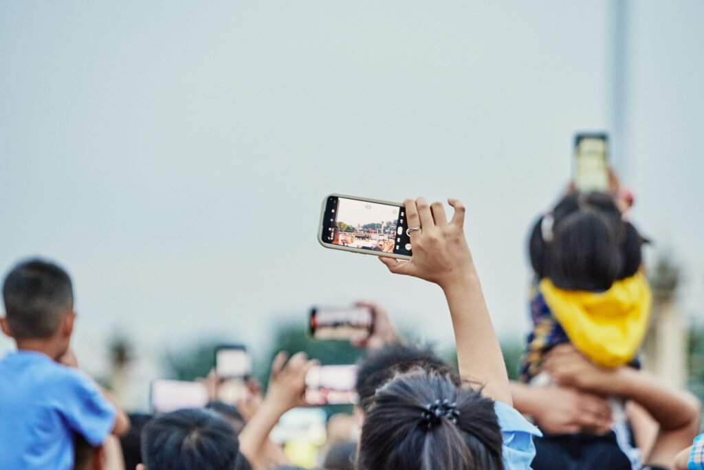 A photo showing a person documenting an accident scene with a smartphone. — filing car insurance claim Nevada