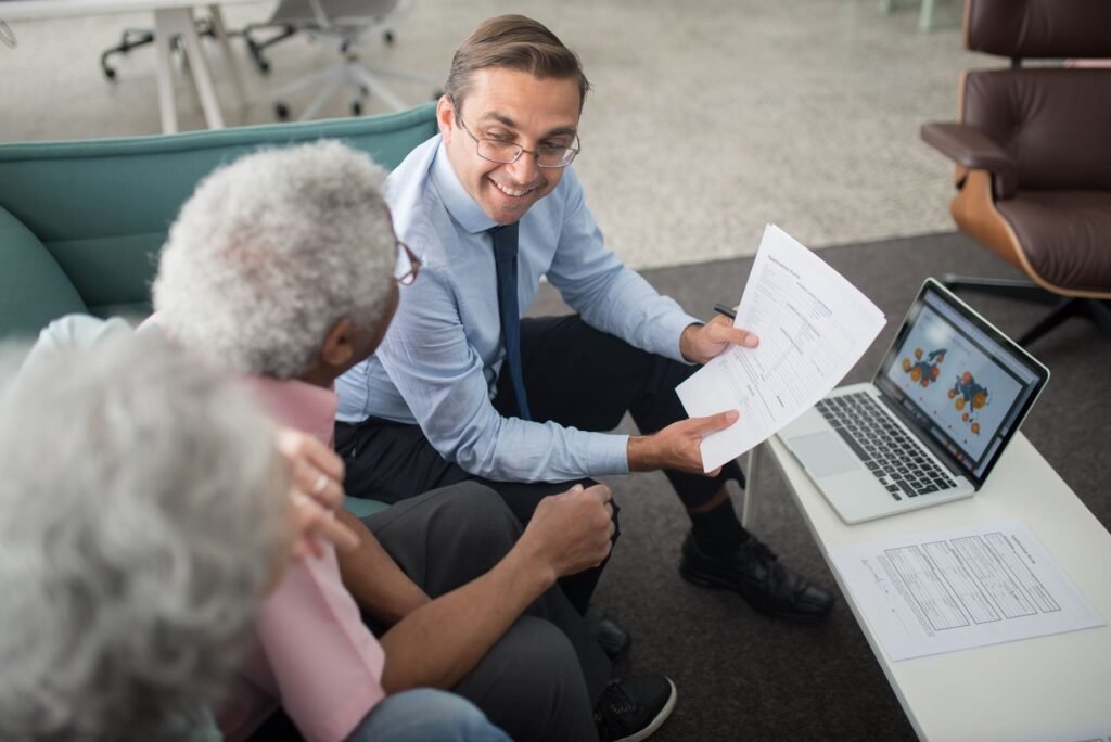 A retired couple discussing their insurance choices with an agent. — bundling insurance Nevada