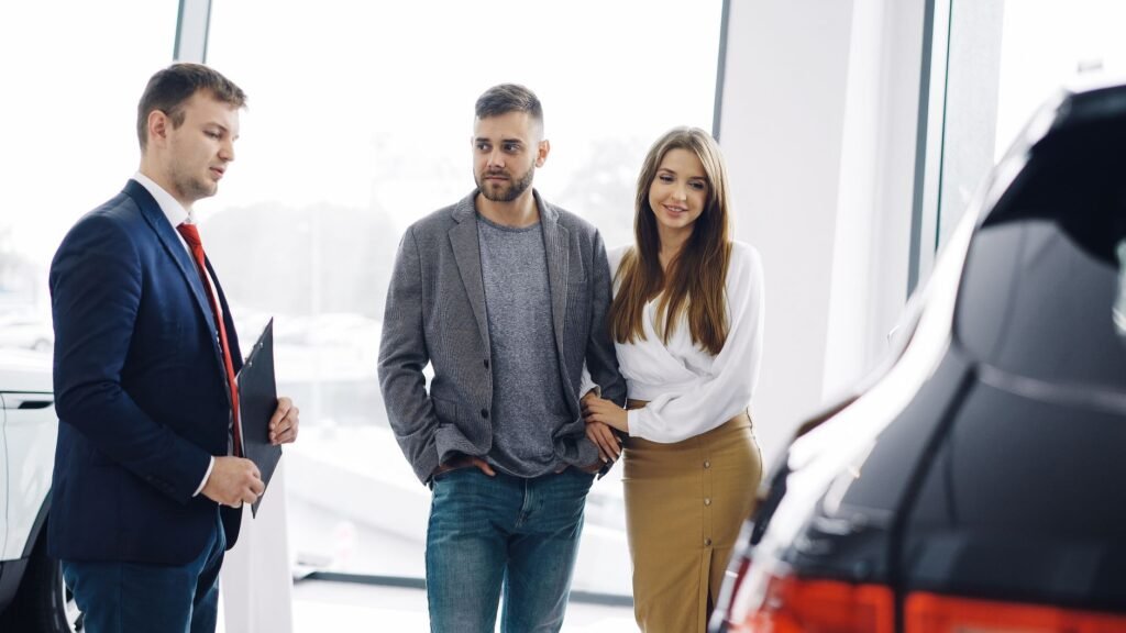 Photo of a family preparing to buy a new car, symbolizing the decision-making process for insurance and the best time to b…